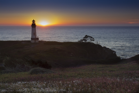 Sunset at Yaquina Head lighthouse along the Oregon Coast by Bonnie Moreland