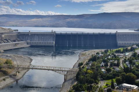 Aerial view of large dam and hydroelectric power facility.
