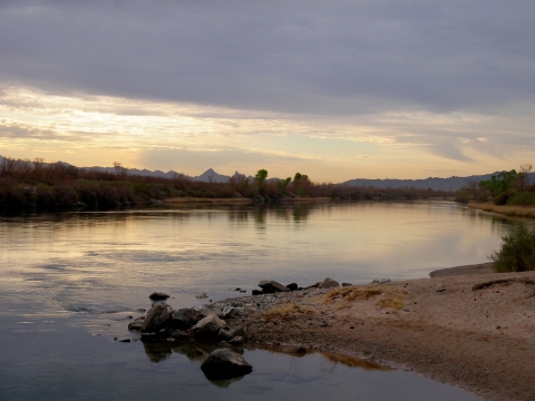 A rocky beach on the water at Havasu National Wildlife Refuge is shown.