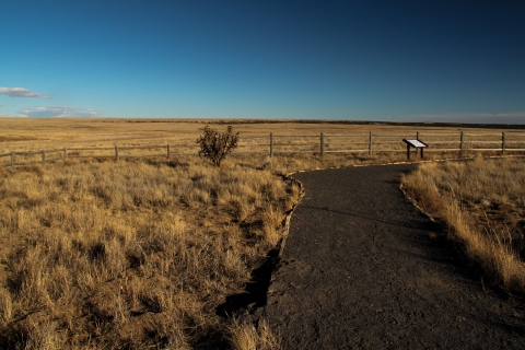 a gravel path through a brown, sandy landscape