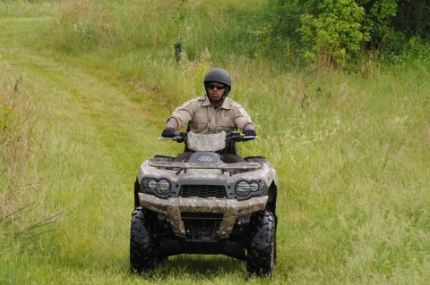Law enforcement officer on patrol riding an ATV