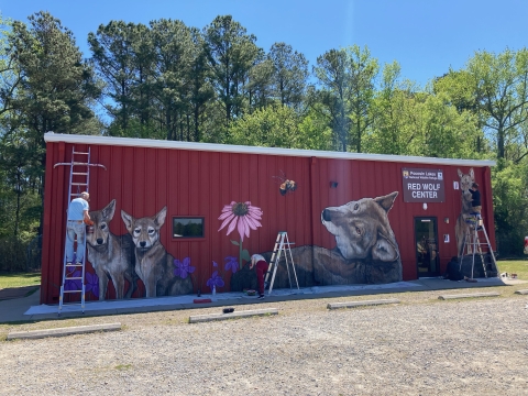 a large red building with animals on it