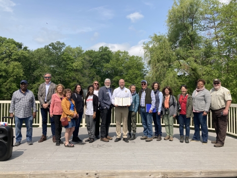 a group of community partners stand together with newly signed Urban Bird Treaty for the City of Hartford