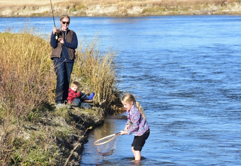 Mom and two kids having family fun day on Seedskadee National Wildlife Refuge. Mom gets an assist on the net.