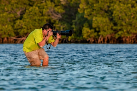 Ernesto Gomez taking photos of wildlife in a wetland