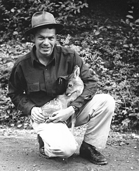 Man holding small fawn