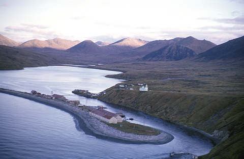 Aerial view of village with mountains in background