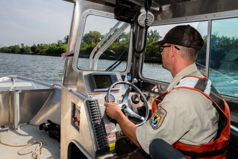 Fishery biologist piloting a boat