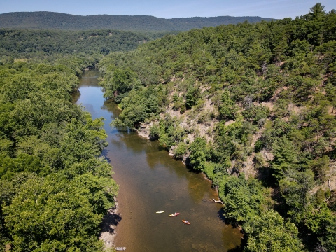 A family kayaks on the Cacapon river