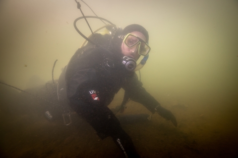 Scuba diver surveys underwater habitat