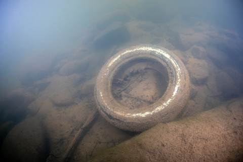 Car tire on river botton