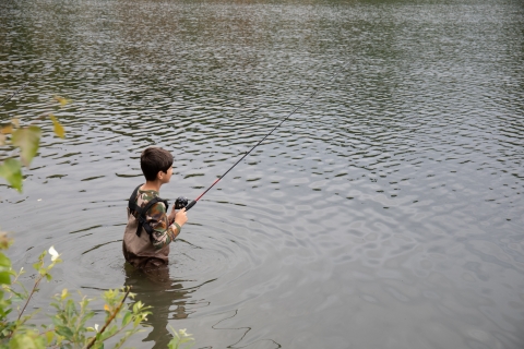 Child fishing in Taku Lake. Partner Anchorage Refugee Assistance Progra,