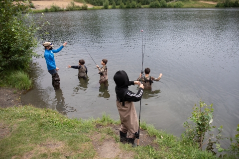 Children fishing in Anchorage. Partner Anchorage Refugee Assistance Program. Taku Lake, Campbell Creek