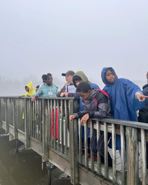 Children on the big board walk at John Heinz NWR wearing wet weather gear