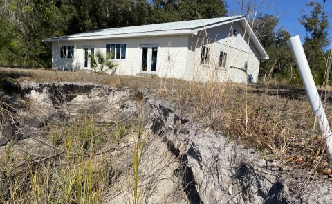 A damaged building along the salt marsh.