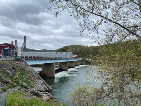 A dam with a bridge over it adjacent to a power plant