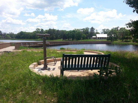 Viewing area with scopes and bench along the Visitor Center Trail's boardwalk