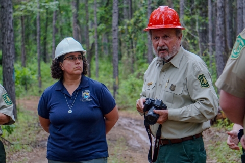 U.S. Fish and Wildlife Service Field Supervisor Brigette Firmin, Louisiana Ecological Services Field Office, and Public Affairs Officer Jim Caldwell discuss timber management in Kisachie National Forest May 7, 2024. 