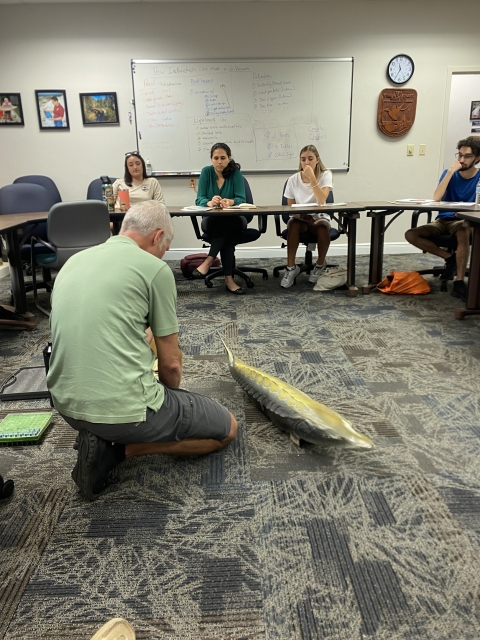 Biologists showing sturgeon to classroom
