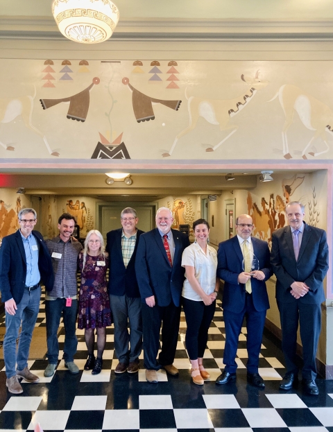 NOAA Team that won the 2023 Presidential Migratory Bird Stewardship Award posing with their award at the Main Interior building
