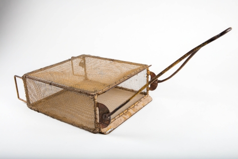 Tan mesh rectangular box with an opening and a wire handle
