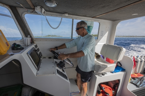 Boat captain behind wheel of boat at Palmyra Atoll