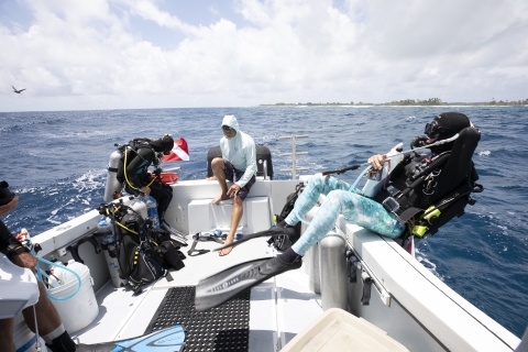 Divers ready to enter water from boat