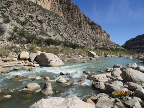 Image of a river showing water flowing over rocks in the river bed