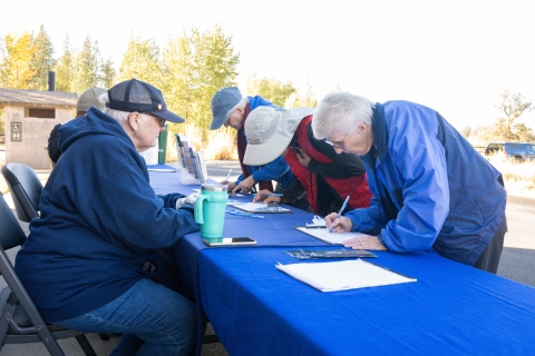 Volunteers signing up to participate in a habitat restoration project
