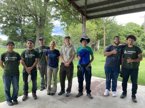 Groundwork Hundson Valley Youth with the artwork winner holding a blue backpack 