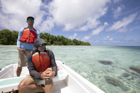 Staff pilot john boat in lagoon
