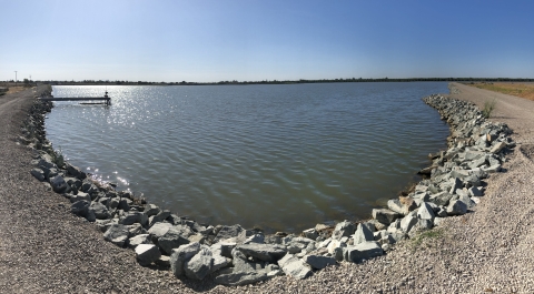 A lake with a sandy shore