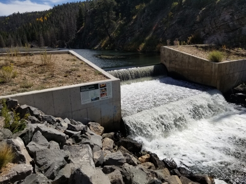 A flowing river over a man-made structure