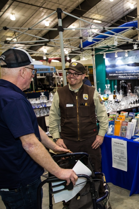 A FWS employee speaking with an event participant