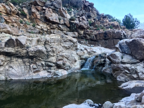A creek with water falling over some rocks