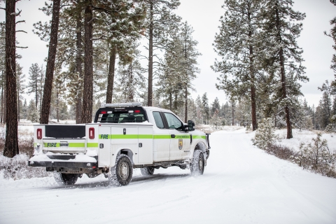 A USFWS fire truck patrols a snow covered road