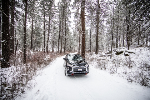 A car drives a snow-covered auto tour route