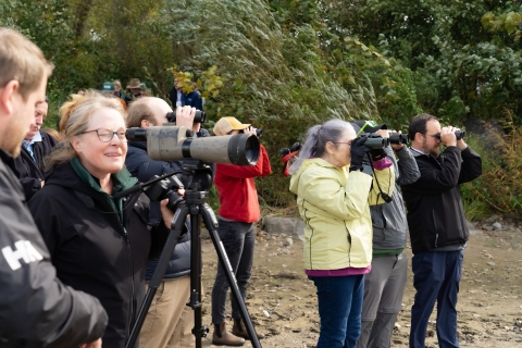 Birdwatchers using a spotting scope at Braddock Bay Wildlife Management Area near Rochester, New York