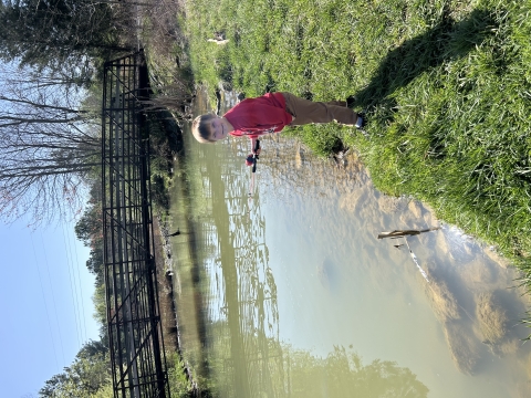 Child fishing at stream