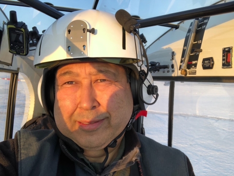 A pilot takes a picture while sitting in a cockpit of a tandem seat super cub airplane