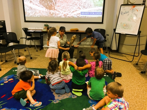 Fish and Wildlife staff conducting the Young Explorer's Club program for a group of children.