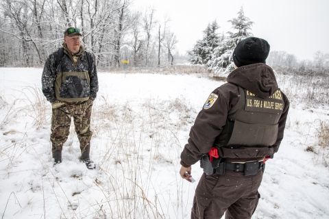 Two officers meeting on a snow covered day