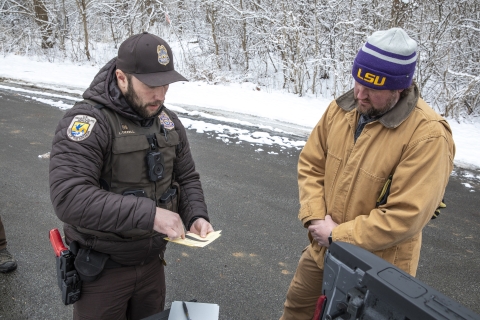 Refuge officer reviewing paperwork with another person