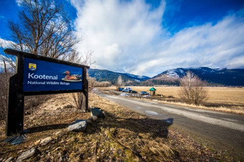 A blue entrance sign denotes the boundary of a national wildlife refuge