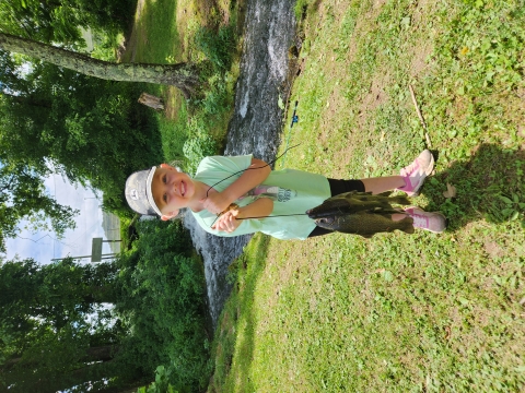 Supper excited young angler with her catch