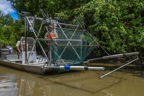 The frame is fully out of the water with most of the trawl netting.