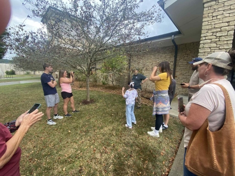 Group of people taking pictures outside of building