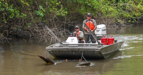 Deploying the trawl. Lowering the otter boards into the water.