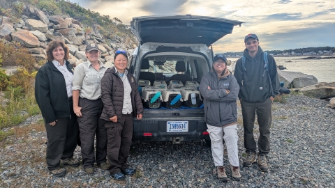 Refuge staff with rabbits in refuge vehicle