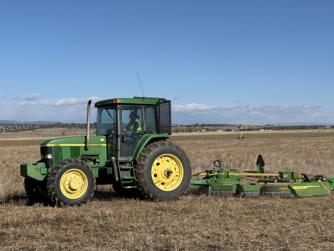 A tractor in a farm pivot being driven by MIFP Intern Mariah.